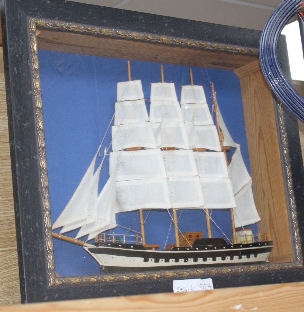 A painted wood ship model, in display frame, overall 42 x 52cm